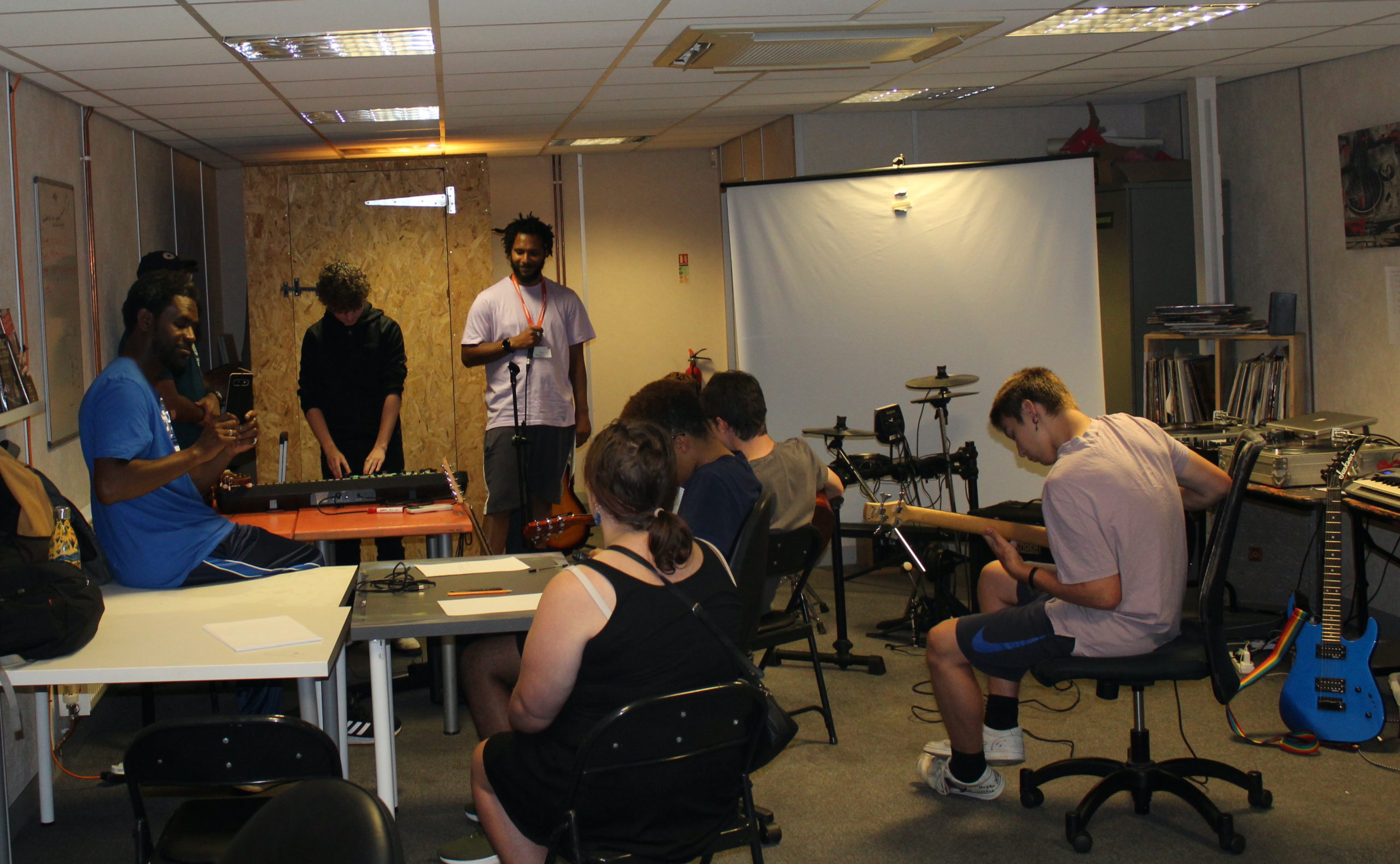Young people playing instruments at a music workshop 